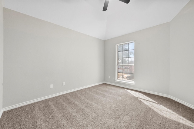 carpeted spare room with ceiling fan and lofted ceiling