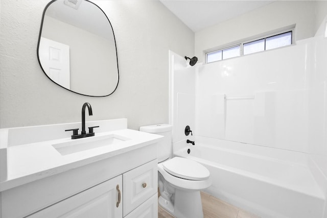 full bathroom featuring vanity, bathing tub / shower combination, and toilet