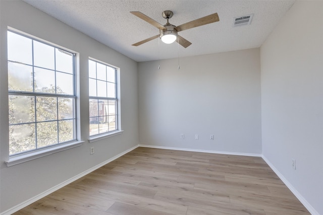 spare room featuring ceiling fan, a textured ceiling, and light hardwood / wood-style flooring