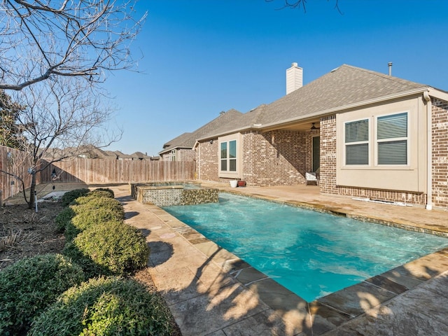 view of swimming pool featuring a patio and ceiling fan