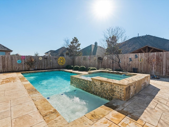 view of pool featuring a patio area, a fenced backyard, and a pool with connected hot tub