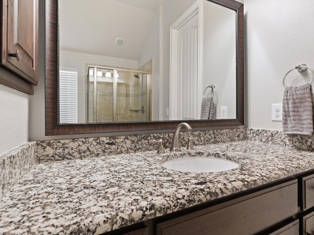 full bathroom featuring a stall shower and vanity