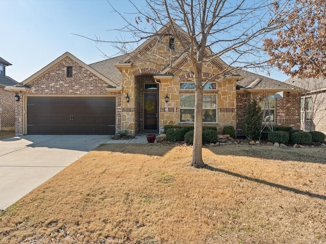 view of front of house featuring a garage, brick siding, stone siding, driveway, and a front lawn