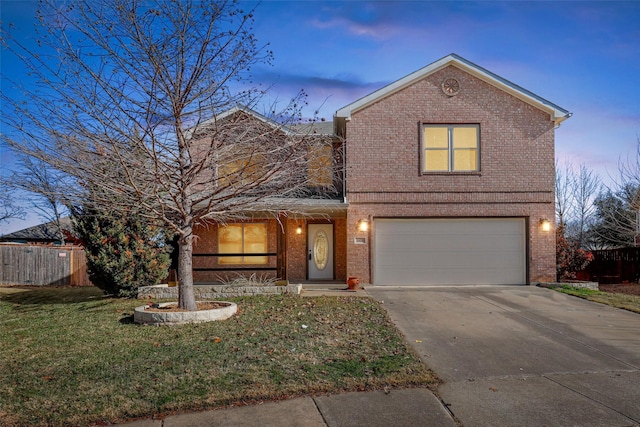 front of property with a garage and a lawn