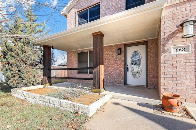 view of exterior entry with covered porch