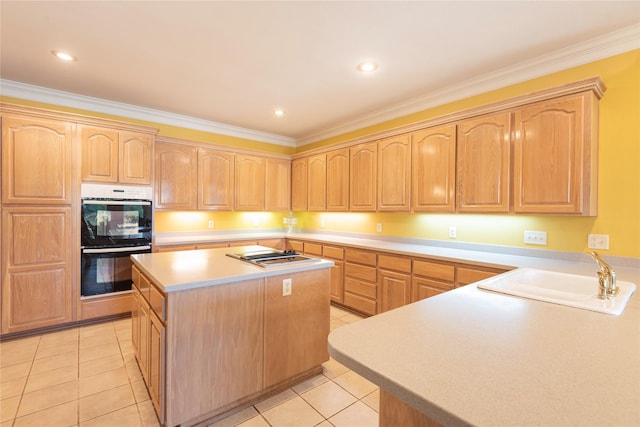 kitchen with sink, light tile patterned floors, ornamental molding, double wall oven, and a kitchen island