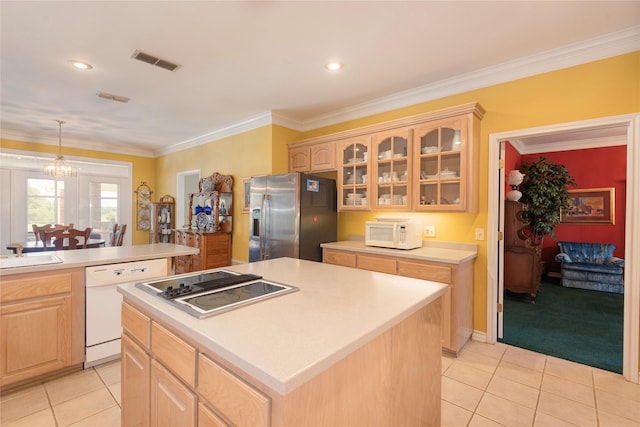 kitchen with crown molding, a center island, light tile patterned floors, light brown cabinets, and stainless steel appliances