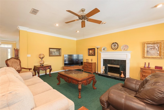 carpeted living room with crown molding, a premium fireplace, and ceiling fan