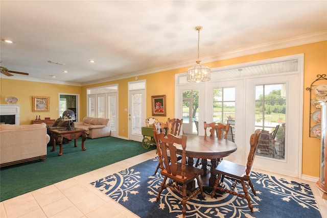 dining room featuring ornamental molding, tile patterned floors, carpet floors, a chandelier, and ceiling fan