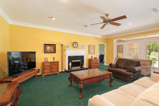 carpeted living room featuring a premium fireplace, ornamental molding, and ceiling fan