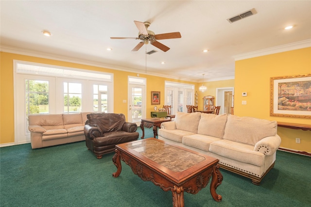 carpeted living room with crown molding and ceiling fan