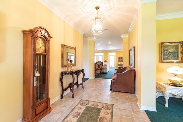 hall featuring light tile patterned floors and crown molding