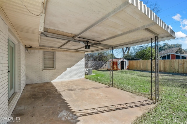 view of patio / terrace featuring central AC, ceiling fan, and a storage unit