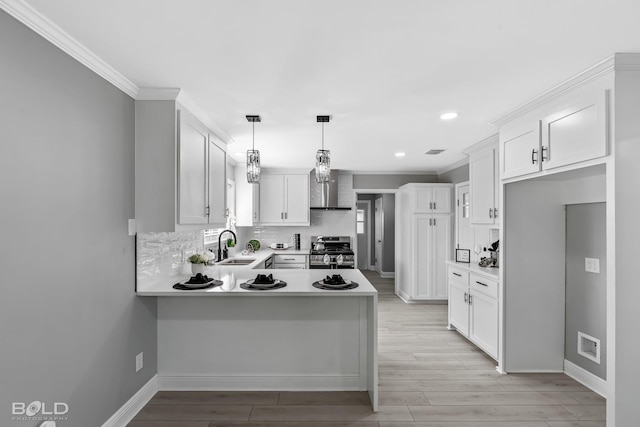 kitchen featuring white cabinetry, pendant lighting, stainless steel range oven, and backsplash