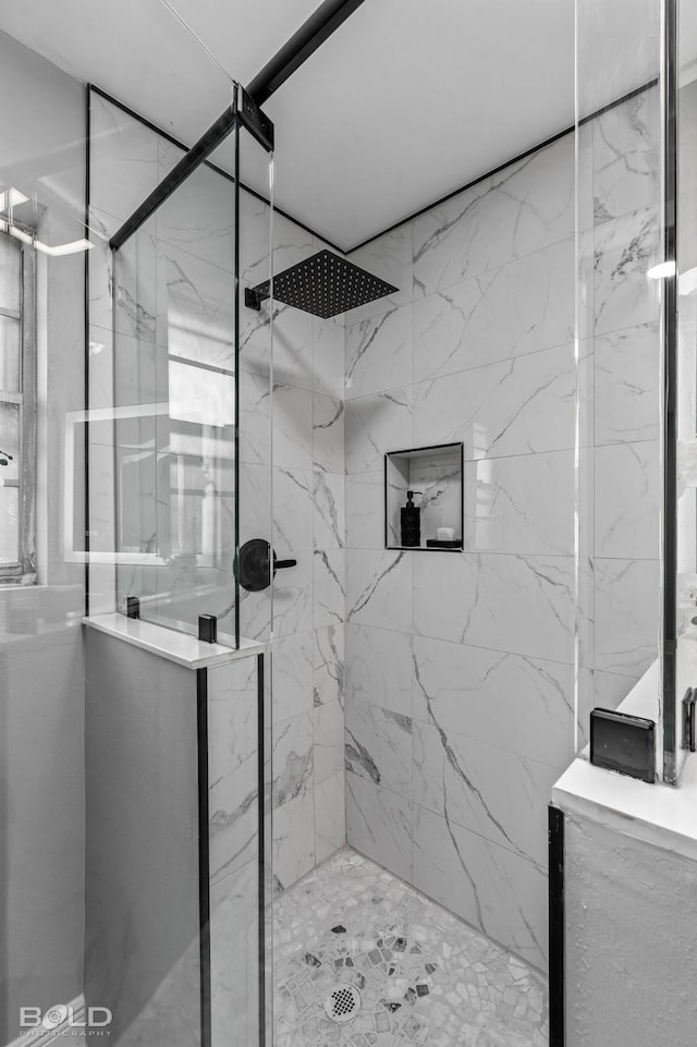 bathroom featuring a shower with shower door