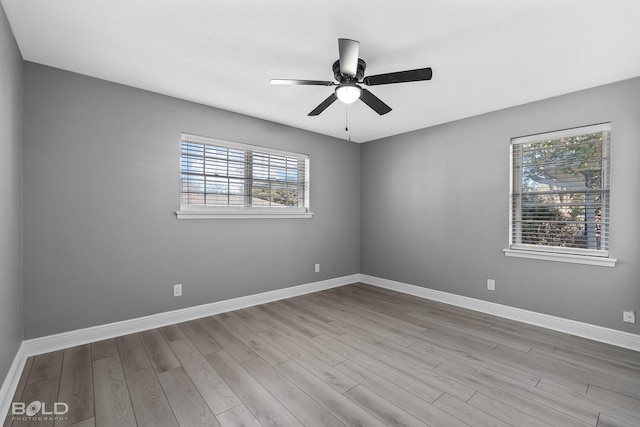 unfurnished room with ceiling fan, light hardwood / wood-style floors, and a wealth of natural light