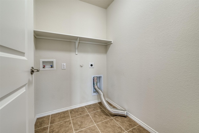 laundry room featuring gas dryer hookup, hookup for an electric dryer, hookup for a washing machine, and dark tile patterned floors