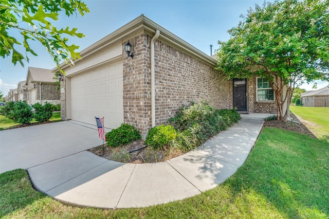 view of front of home featuring a garage and a front lawn