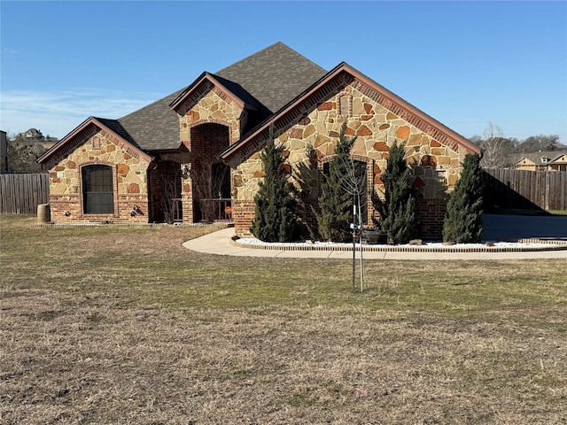 french country style house featuring a front yard