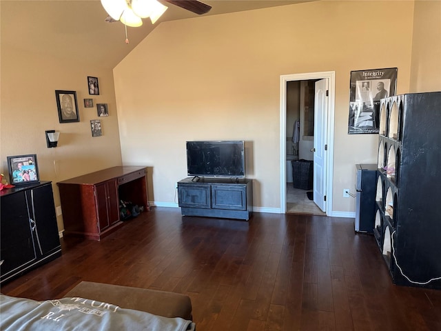 living room featuring ceiling fan, dark hardwood / wood-style flooring, and vaulted ceiling