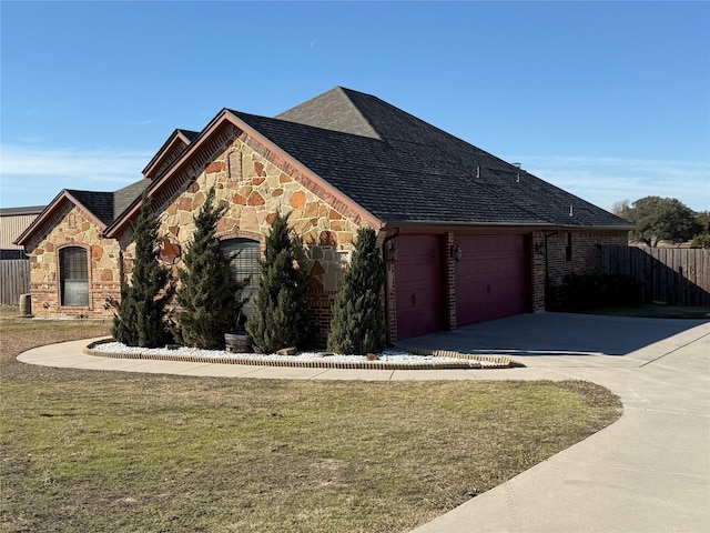 view of front of property with a garage and a front lawn