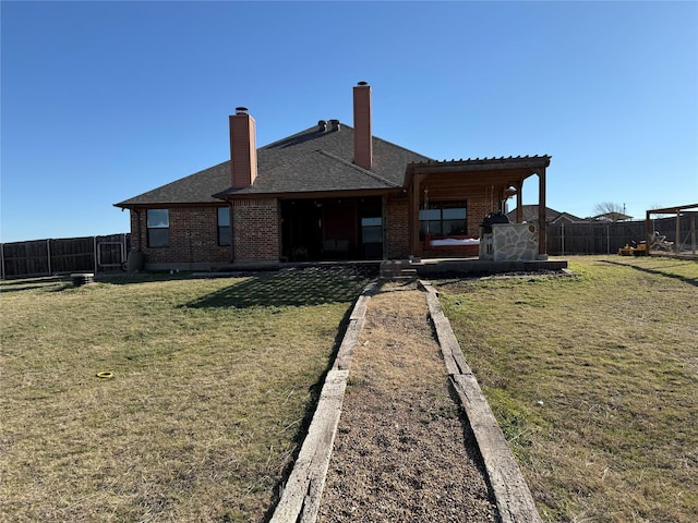 rear view of property with a yard