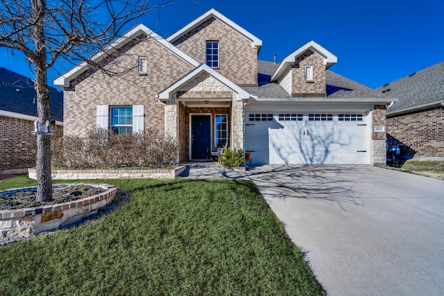 view of front of property with a garage and a front yard