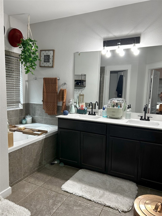 full bathroom with a sink, a garden tub, and double vanity