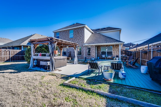 rear view of property featuring a pergola, a deck, a fenced backyard, a shingled roof, and a hot tub