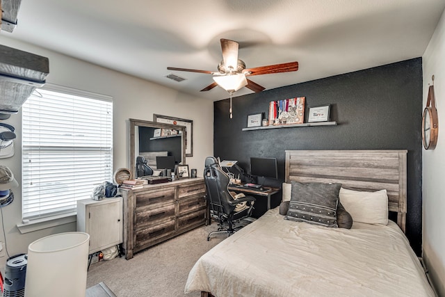 bedroom featuring multiple windows, carpet, ceiling fan, and visible vents