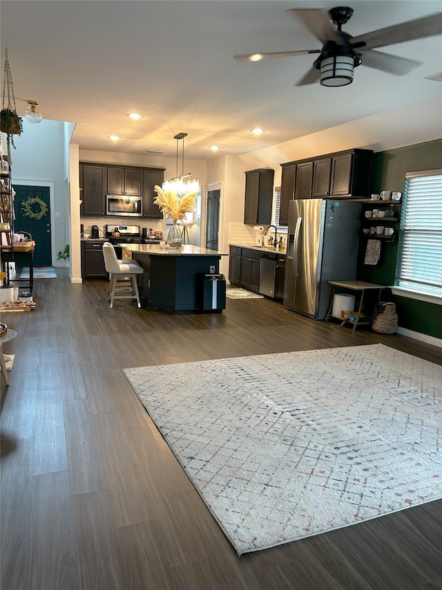 living room featuring recessed lighting, ceiling fan, and dark wood-style floors
