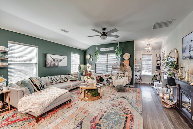 living room featuring dark wood-type flooring, ceiling fan, and vaulted ceiling