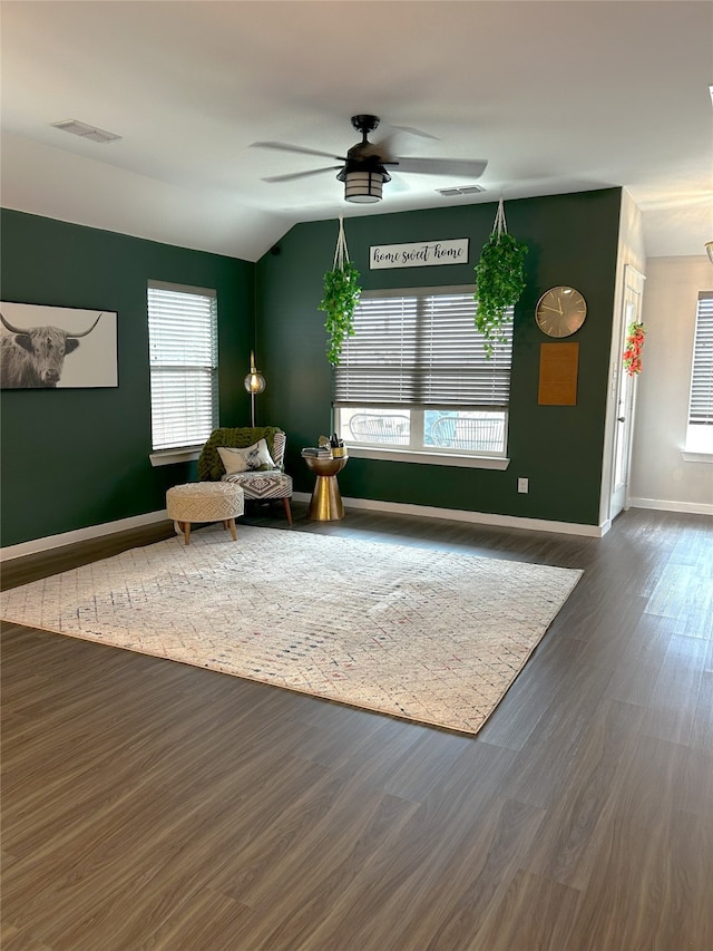 sitting room featuring baseboards, ceiling fan, visible vents, and wood finished floors
