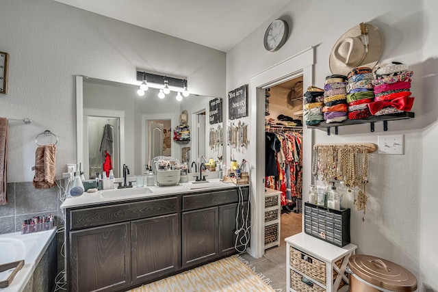 bathroom with vanity, tile patterned floors, and a bathtub