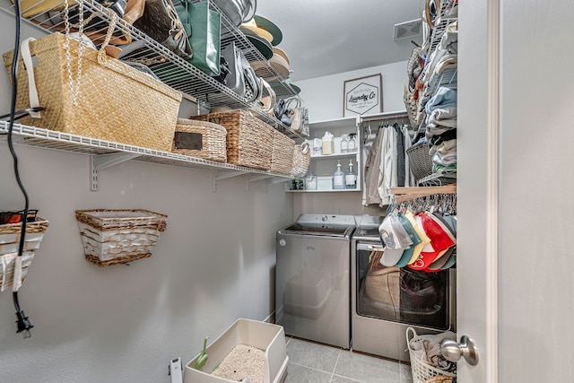 laundry room featuring light tile patterned flooring and washing machine and clothes dryer