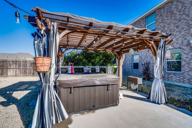 view of patio / terrace with a fenced backyard, a pergola, and a hot tub