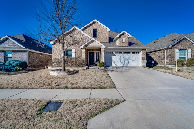 traditional-style house featuring concrete driveway, brick siding, an attached garage, and a shingled roof
