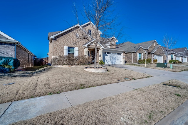 view of front of property with fence, brick siding, an attached garage, driveway, and a residential view