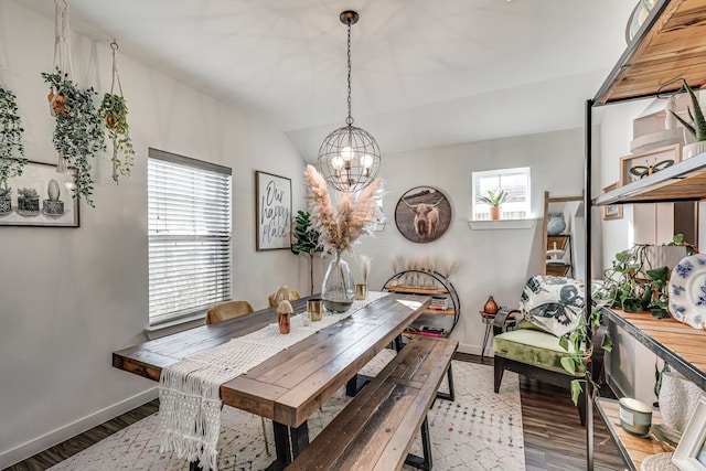 dining room with hardwood / wood-style floors, vaulted ceiling, and a wealth of natural light