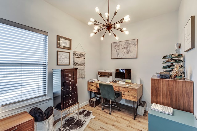 home office with a chandelier and light hardwood / wood-style floors