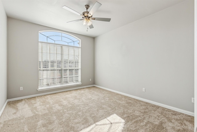 empty room featuring ceiling fan and light carpet