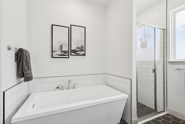 bathroom featuring tile patterned floors and independent shower and bath