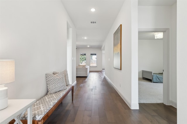 corridor with dark hardwood / wood-style flooring