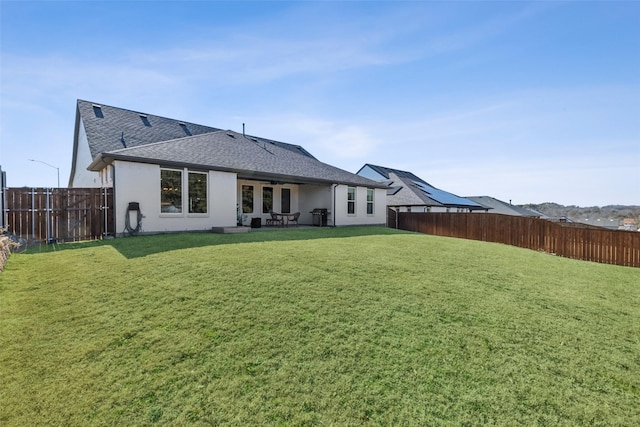 back of house featuring a lawn