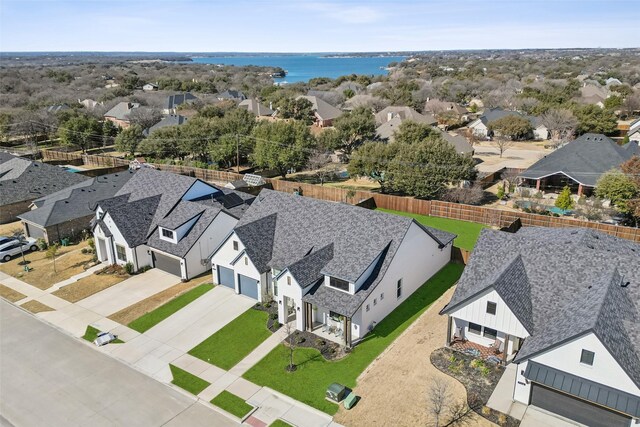 birds eye view of property featuring a residential view and a water view