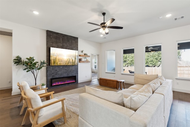 living room with a fireplace, dark hardwood / wood-style floors, and ceiling fan