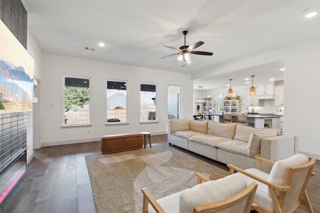 living room with hardwood / wood-style flooring and ceiling fan