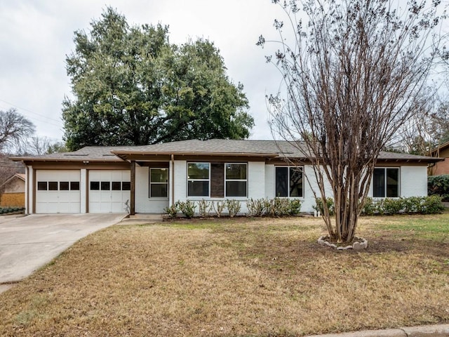 single story home featuring a garage and a front lawn