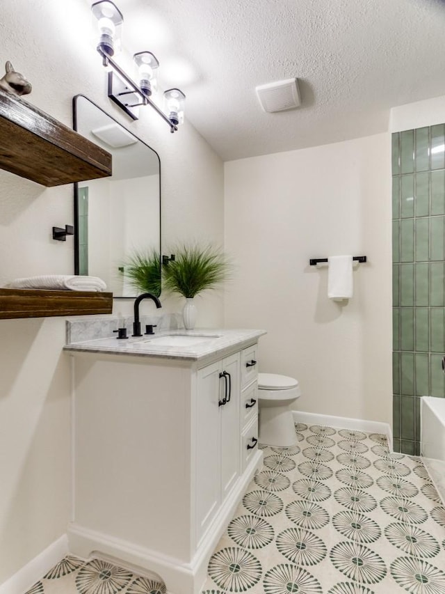 full bathroom with vanity, toilet, a textured ceiling, and separate shower and tub