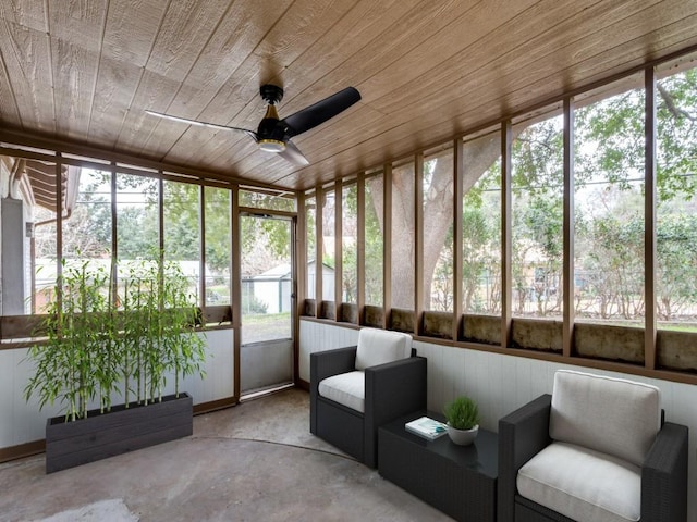 unfurnished sunroom with wood ceiling and ceiling fan